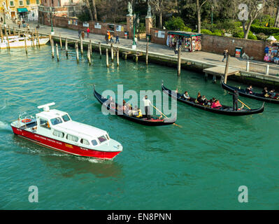 Tourists ride in iconic gondolas, Venice, Italy, City of Canals Stock Photo