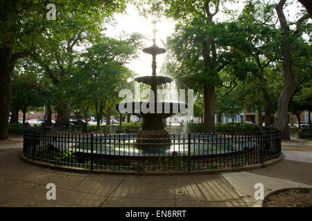 Water flowing in the fountain in the Bienville Square City Park in downtown Mobile, Alabama in the afternoon sunlight. Stock Photo