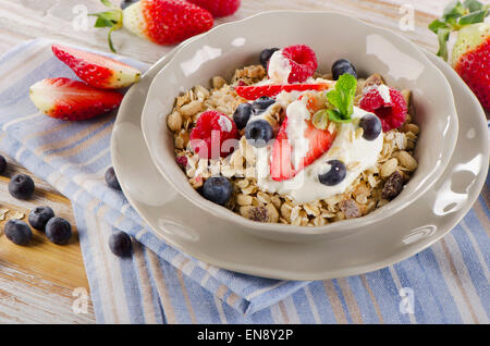 Breakfast with fresh berries, yogurt and  muesli. Selective focus Stock Photo