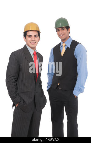Close up of two asian professional men standing together wearing helmets Stock Photo