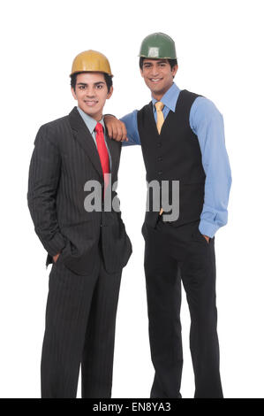 Close up of two asian professional men standing together wearing helmets Stock Photo