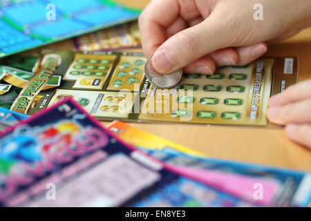 Coquitlam BC Canada - June 15, 2014 : Woman scratching lottery tickets. The British Columbia Lottery Corporation Stock Photo