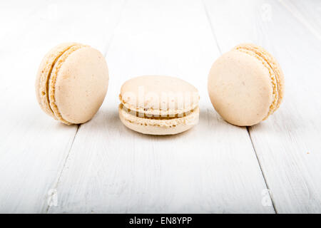 Set of macarons isolated on white wooden table Stock Photo