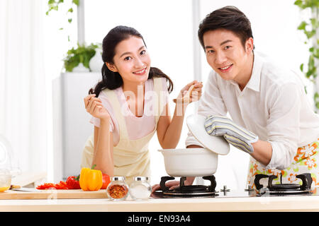 Young couple preparing food in kitchen