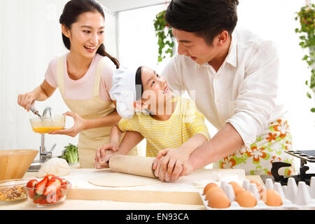 Family preparing food in kitchen Stock Photo