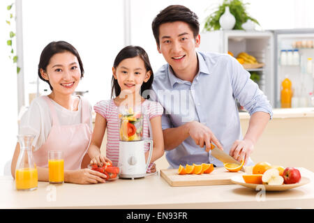 Family preparing food in kitchen Stock Photo