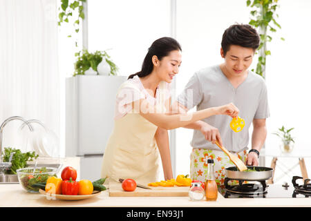 Young couple preparing food in kitchen Stock Photo