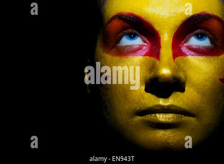 Portrait of a mysterious woman with artistic make-up on her face. Isolated on black background Stock Photo