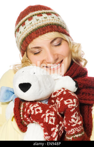 Beautiful girl in winter clothing with a polar bear toy Stock Photo