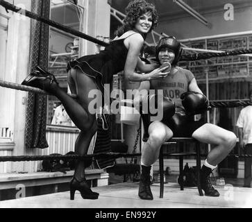 Boxer Chris Finnegan is happy to be on the receiving end for once. For that is actress Julie Ege, a knock-out by any standards, giving him the treatment. The Lavender Hill Mob-a group of boxers who train at a pub in Lavender Hill London chose Julie as the Stock Photo