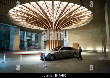 A man closes the door of a luxury car in an office in downtown Kuala Lumpur, Malaysia Stock Photo