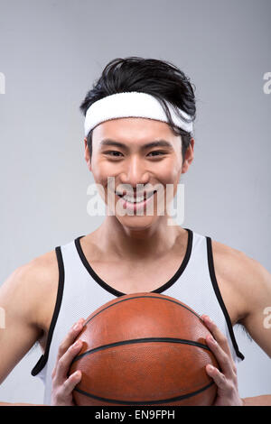 Portrait of young man with basketball Stock Photo