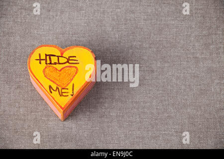 A heart-shaped trinket box with Hide Me written on the top Stock Photo