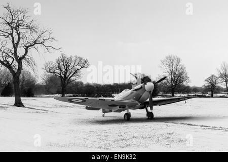 RAF Supermarine Spitfire at rest in a snowy field in the winter of 1940/41. Black and white version of this image. Stock Photo