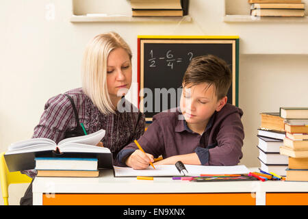 Young student engaged with the teacher. Stock Photo