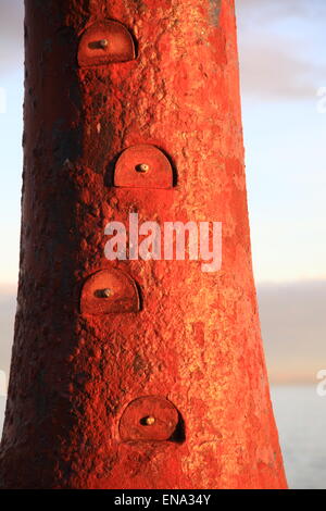 Anstruther, tower located at the end of the harbour, red in the setting sun,footholds to climb to the top some stopped up safety Stock Photo