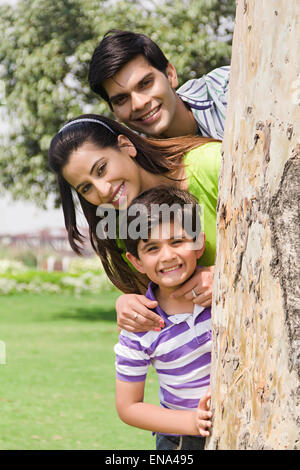 indian Parents and son park playing Hide and Seek Stock Photo