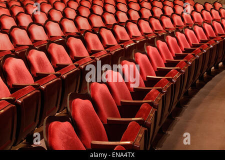 Rows of red velvet theater seats in an old Vaudeville style theater. Stock Photo