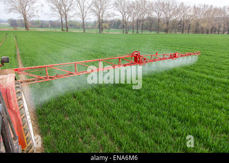 Spraying machine working on the green field Stock Photo