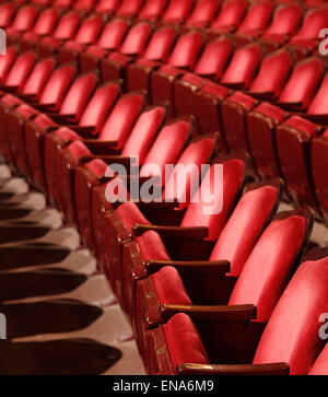 Rows of red velvet theater seats in an old Vaudeville style theater. Stock Photo