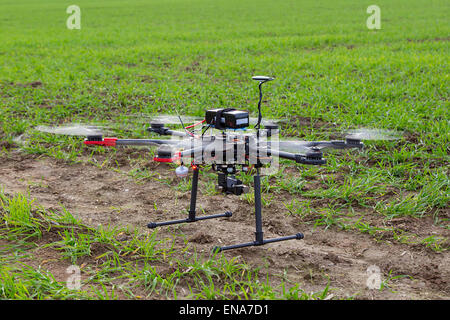 The small drone hexacopter flying over the field Stock Photo