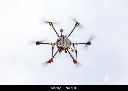 The small drone hexacopter flying over the field Stock Photo