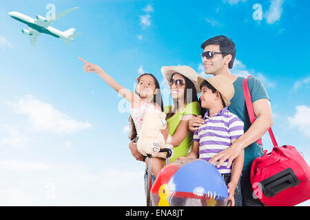 indian Parents and kids happy Journey showing Aeroplane Stock Photo
