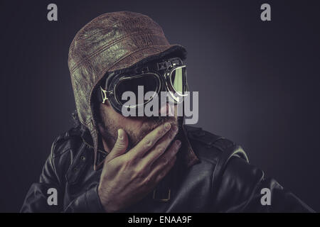 jacket, pilot dressed in vintage style leather cap and goggles Stock Photo