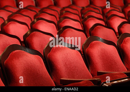 Rows of red velvet theater seats in an old Vaudeville style theater. Stock Photo