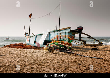 A fisherman servicing his nets at Colva Beach, Goa. Stock Photo