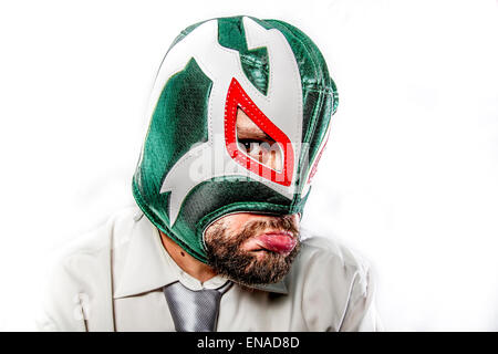 sad, aggressive businessman with Mexican warrior mask Stock Photo