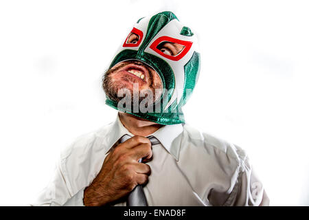 stress, aggressive businessman with Mexican warrior mask Stock Photo
