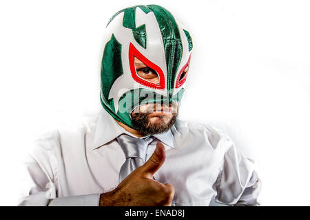 aggressive businessman with Mexican warrior mask Stock Photo