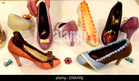 Oldisleben, Germany. 10th Apr, 2015. Edible high heels can be seen in the display area in Karin Finger's Goethe Chocolate Factory in Oldisleben, Germany, 10 April 2015. The colorful high-heeled shoes are part of the extensive, high-quality praline production at her company, which was founded ten years ago. Photo: WALTRAUD GRUBITZSCH/dpa/Alamy Live News Stock Photo