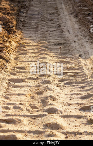 wheel track and foot print on clay road Stock Photo