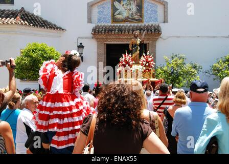 Crowd watching the Statue of Saint Bernard on a float being carried into the church during the Romeria San Bernabe, Marbella. Stock Photo