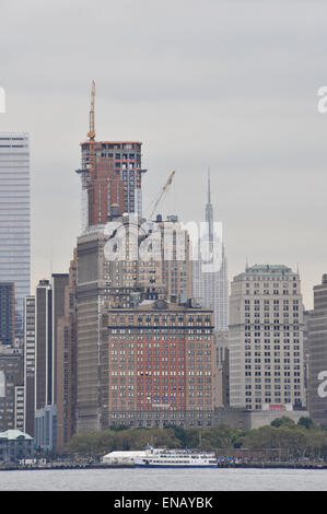 The Empire State building seen through New York towers from the river Stock Photo