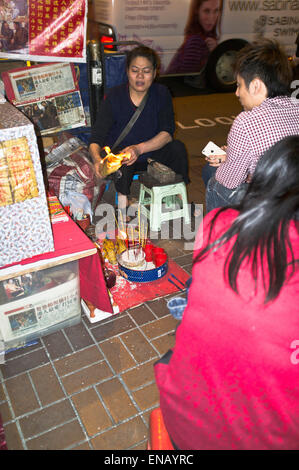 dh Fortuneteller CAUSEWAY BAY HONG KONG Chinese fortune teller woman burning paper foretelling mans future telling Stock Photo