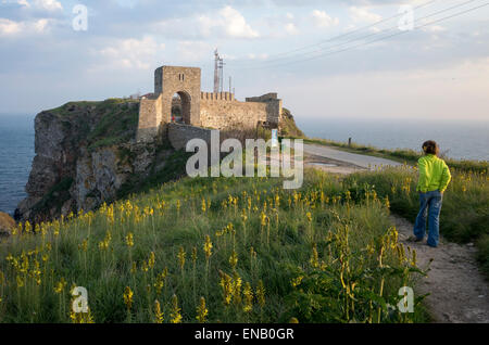 Child on path in front of the north tower, wall and gate of the citadel at Cape Kaliakra with the Black Sea in the background Stock Photo