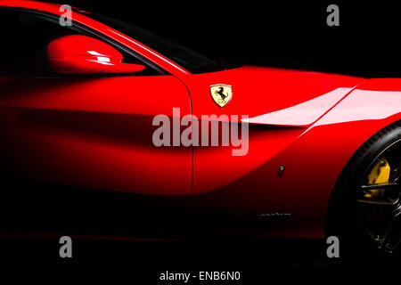 Ferrari F12 in red side shot of vent, mirrors and logo on a black background. Stock Photo