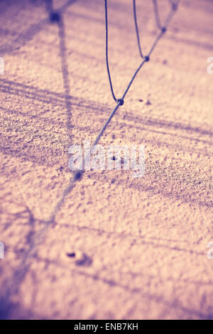 Vintage filtered holes in sand made by rain drops from fence, shallow depth of field, nature background. Stock Photo