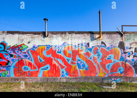 Saint-Petersburg, Russia - April 6, 2015: Colorful abstract graffiti painted on old gray concrete garage walls Stock Photo