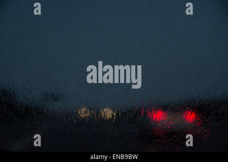 Difficult driving conditions at night - view through rain on windscreen - UK motorway Stock Photo