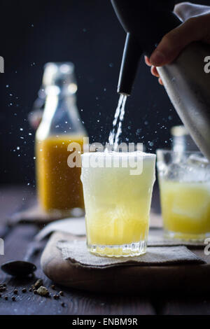 A Mumbai Mule cocktail in a glass on a wooden background. Stock Photo