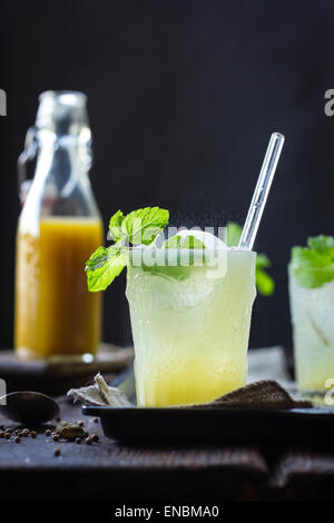 A Mumbai Mule cocktail in a glass on a wooden background. Stock Photo