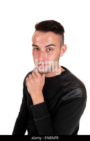 A young handsome man in a profile picture in a black sweater with his hand on his chin, isolated on white background. Stock Photo