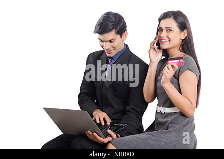 2 indian Business Colleague laptop and phone Credit Card shopping Stock Photo