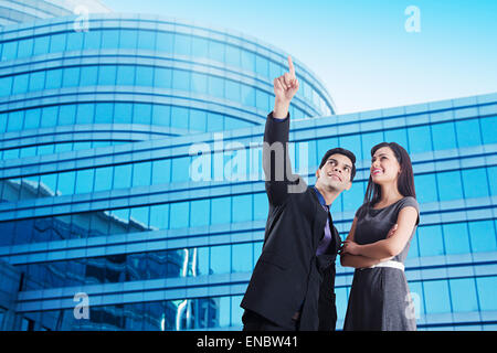 2 indian Business Colleague pointing Showing Stock Photo