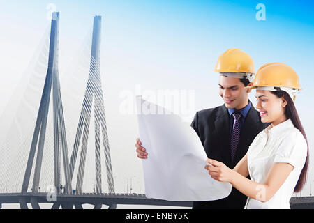 2 indian Engineer Colleague Bridge site map Checking Stock Photo