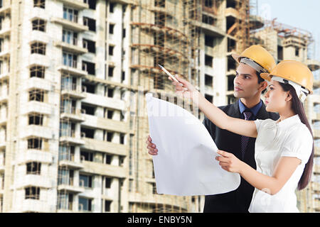 2 indian Engineer Colleague Concentration site Planning map Checking Stock Photo